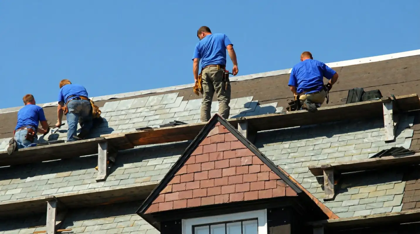 Roof replacement in progress with a team of professional contractors installing new shingles on a residential home in Columbia, SC