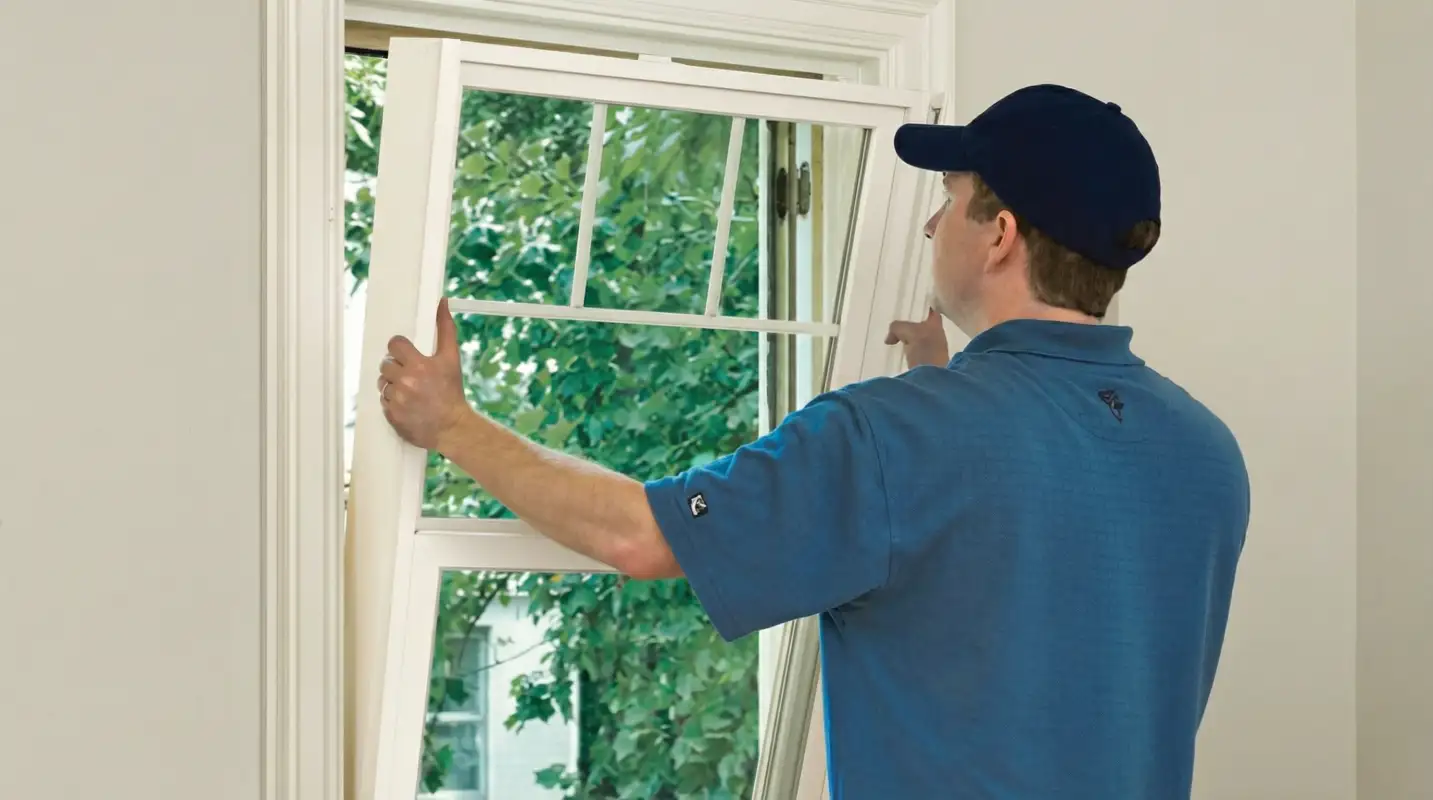 Professional contractors performing a residential window insulation and replacement service in Columbia, SC